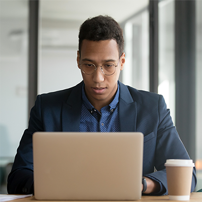 Man seated in front of a laptop computer.